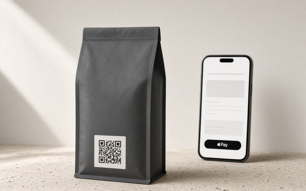 A coffee bag with a QR code on its label, beside a phone showing the checkout with Apple Pay